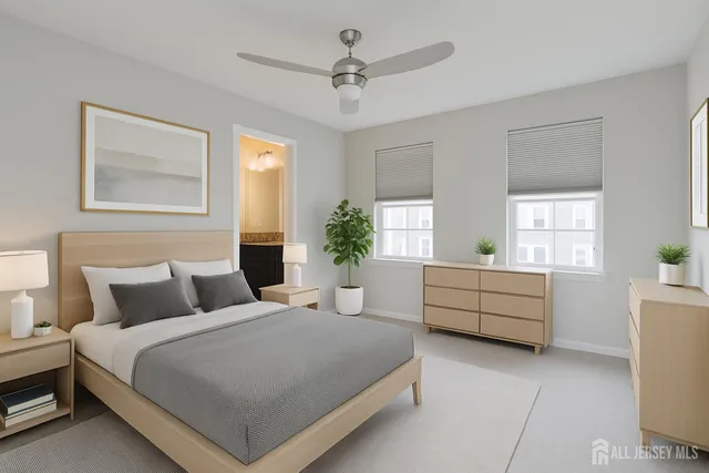 a bedroom with a large bed and windows