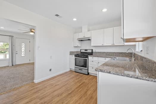 2982 D Street Selma, CA 93662 - Photo 17 of 25 a kitchen with granite countertop a stove and a sink