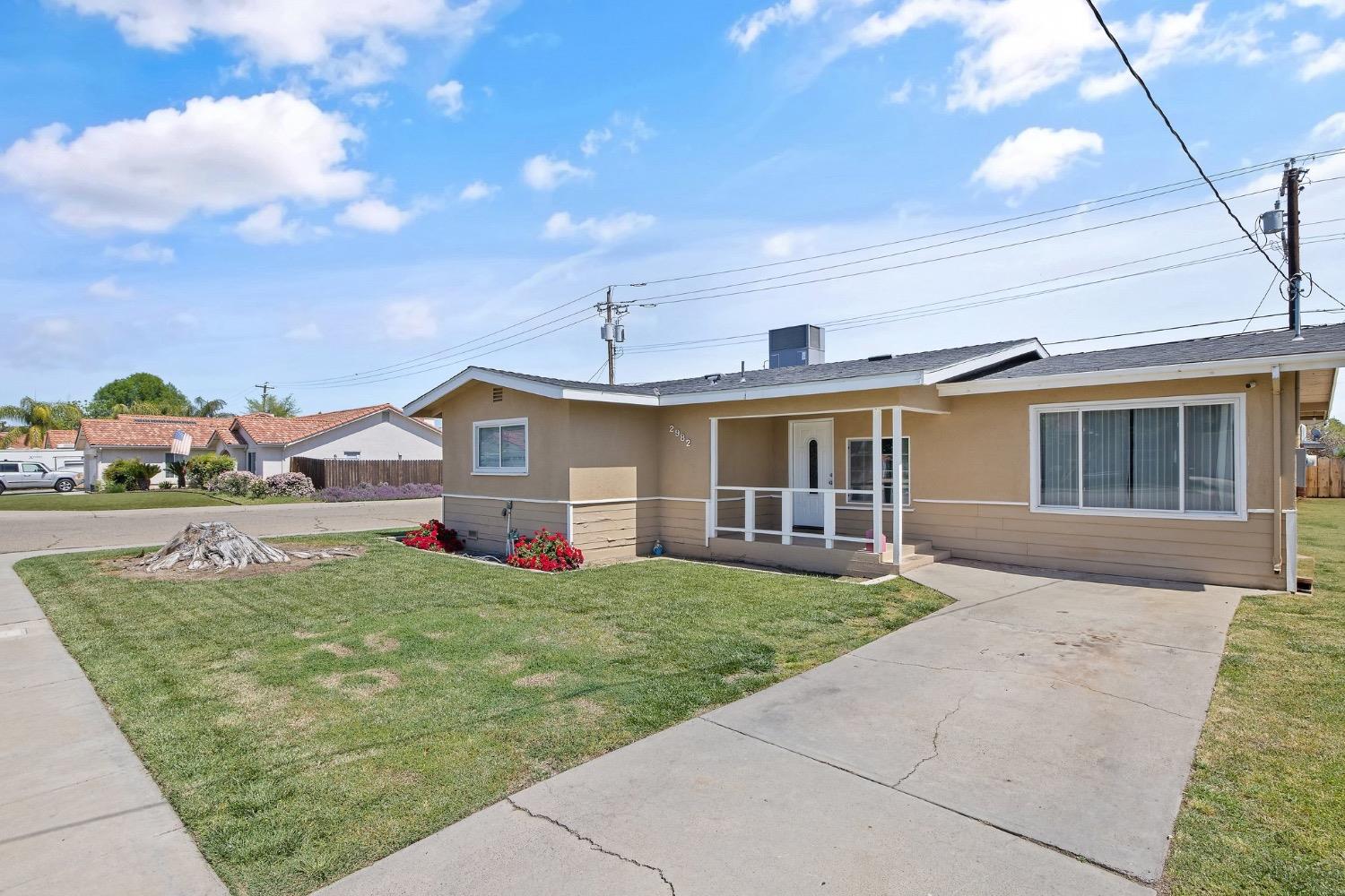 2982 D Street Selma, CA 93662 - Photo 2 of 25 a front view of a house with a yard outdoor seating and barbeque oven