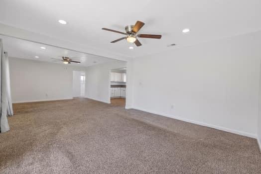 2982 D Street Selma, CA 93662 - Photo 6 of 25 an empty room with chandelier fan and windows