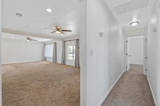 2982 D Street Selma, CA 93662 - Photo 10 of 25 a view of a hallway with a chandelier fan and windows