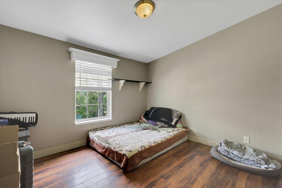 10268 Peoria Road Browns Valley, CA 95918 - Photo 13 of 57 a bedroom with a bed and wooden floor