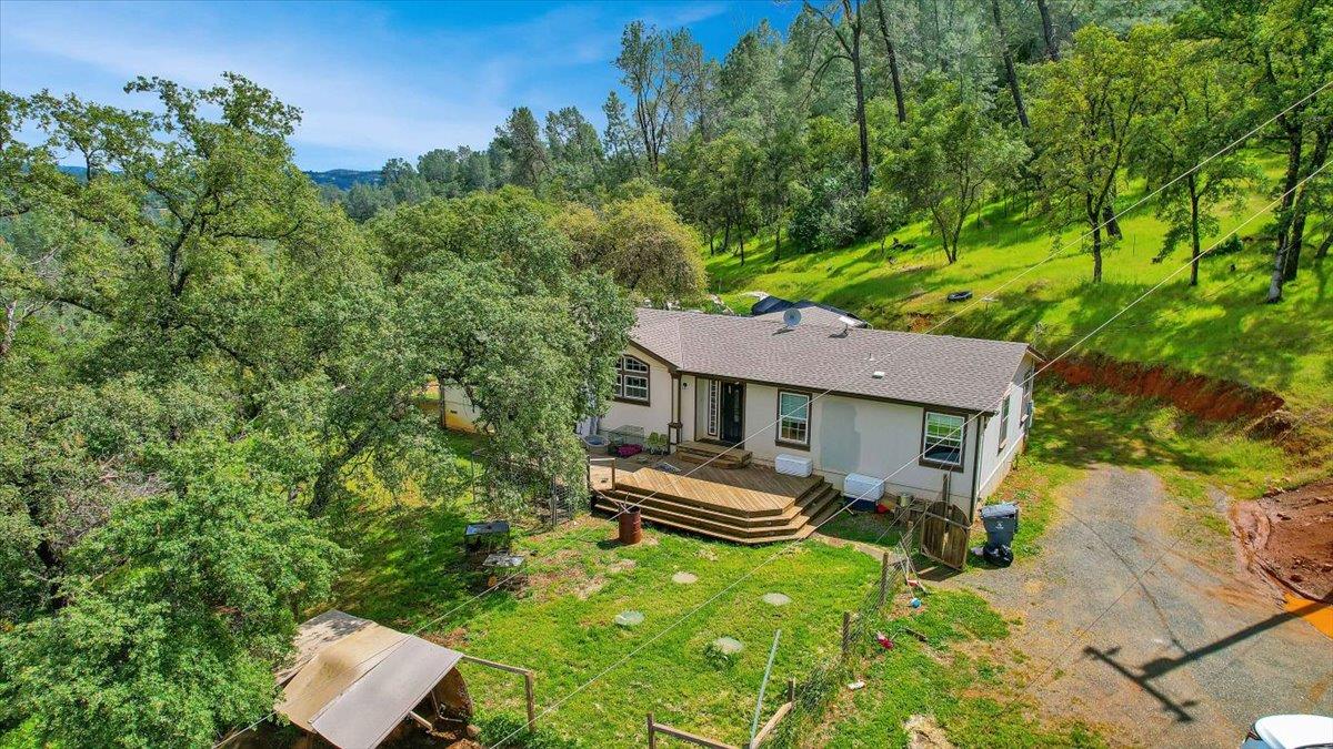10268 Peoria Road Browns Valley, CA 95918 - Photo 40 of 57 a backyard of a house with table and chairs and wooden fence