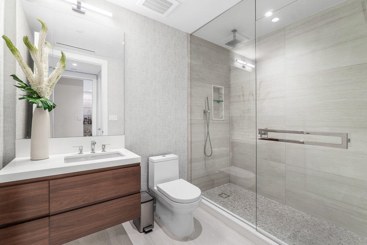 200 Southeast Mizner Boulevard, Unit 211 Boca Raton, FL 33432 - Photo 28 of 67 a bathroom with a toilet a sink and shower