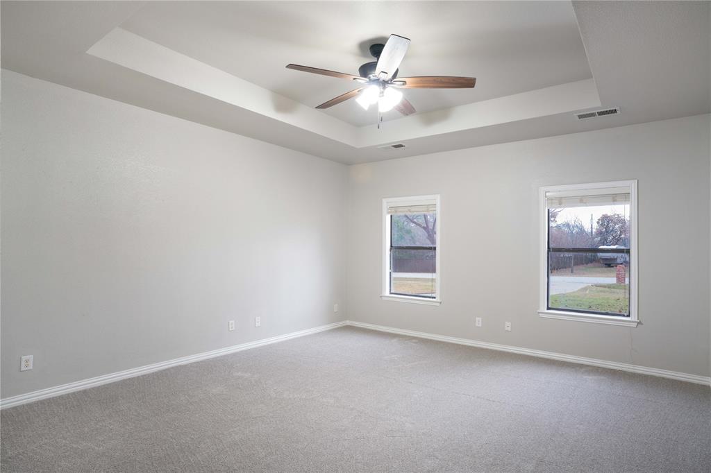 250 Timberleaf Drive Double Oak, TX 75077 - Photo 11 of 23 an empty room with windows and fan