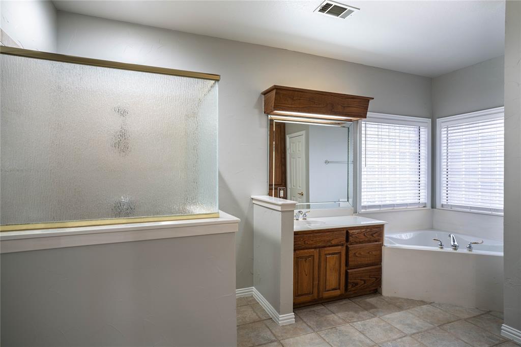 250 Timberleaf Drive Double Oak, TX 75077 - Photo 12 of 23 a bathroom with a tub sink and mirror