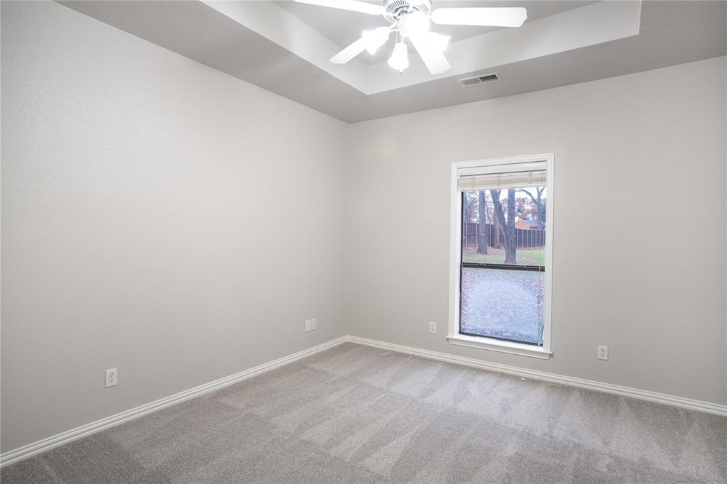 250 Timberleaf Drive Double Oak, TX 75077 - Photo 14 of 23 an empty room with a fan & a window