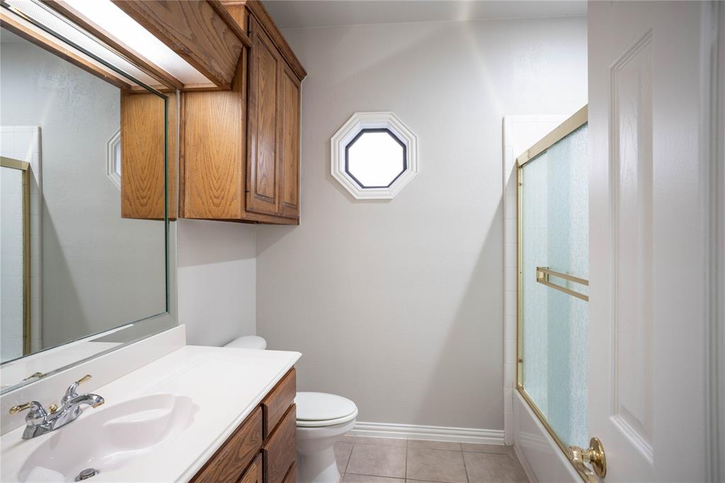 250 Timberleaf Drive Double Oak, TX 75077 - Photo 15 of 23 a bathroom with a sink a toilet and shower