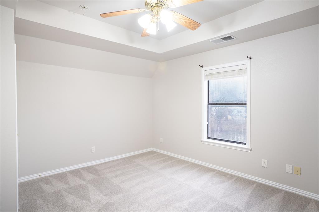 250 Timberleaf Drive Double Oak, TX 75077 - Photo 20 of 23 an empty room with a window and a ceiling fan