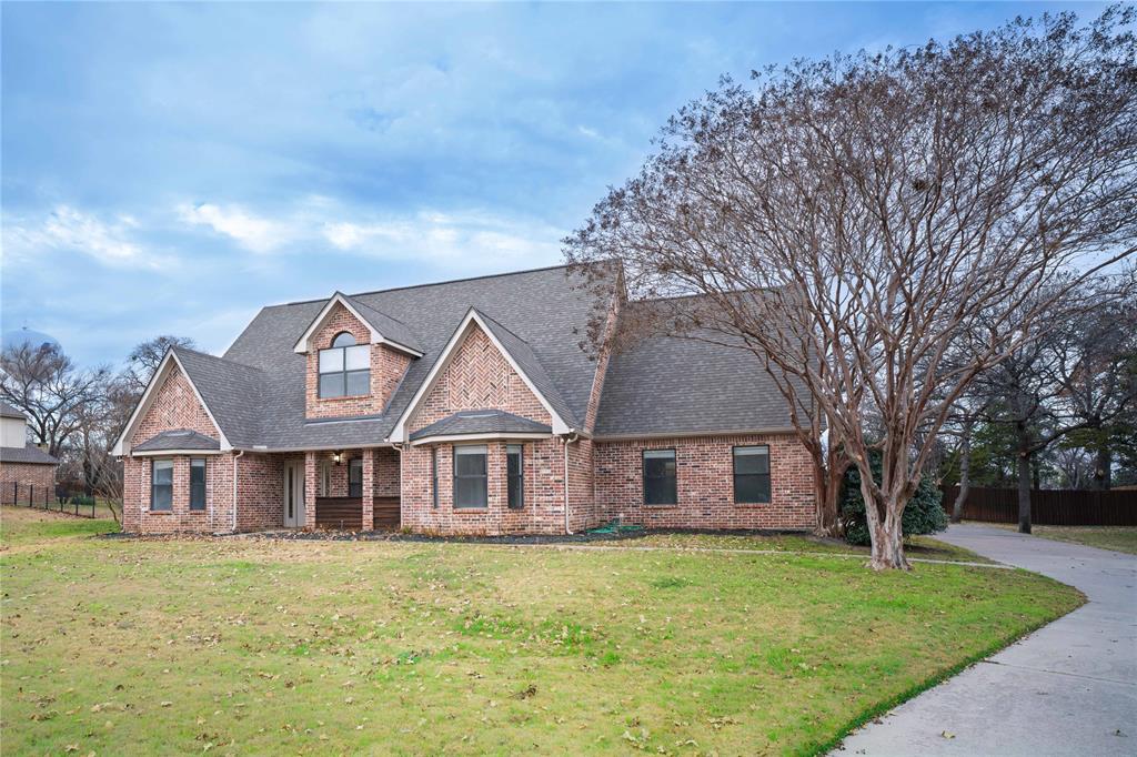 250 Timberleaf Drive Double Oak, TX 75077 - Photo 2 of 23 a front view of a house with a garden and trees