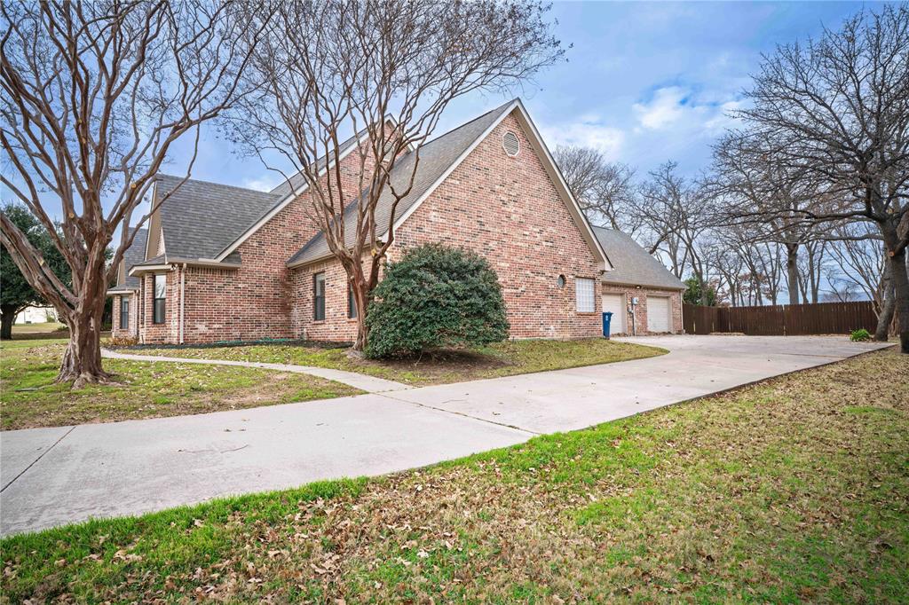 250 Timberleaf Drive Double Oak, TX 75077 - Photo 3 of 23 a view of a yard with plants and trees