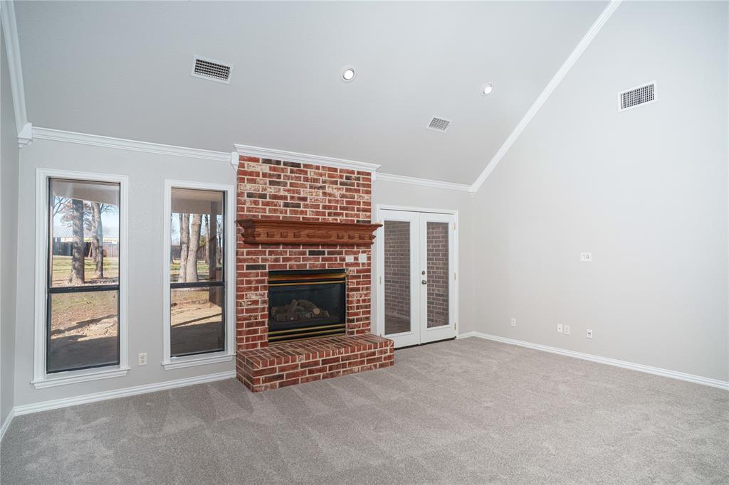 250 Timberleaf Drive Double Oak, TX 75077 - Photo 4 of 23 a view of an empty room with a fireplace