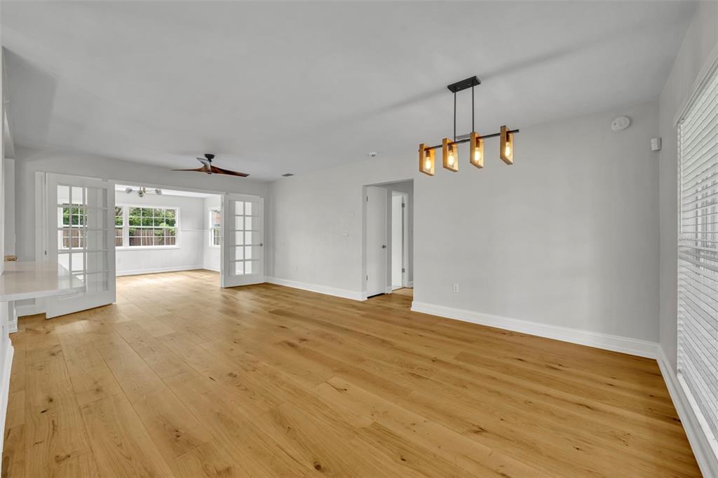 4234 Kendrick Road Orlando, FL 32804 - Photo 4 of 46 a view of an empty room with wooden floor and a window
