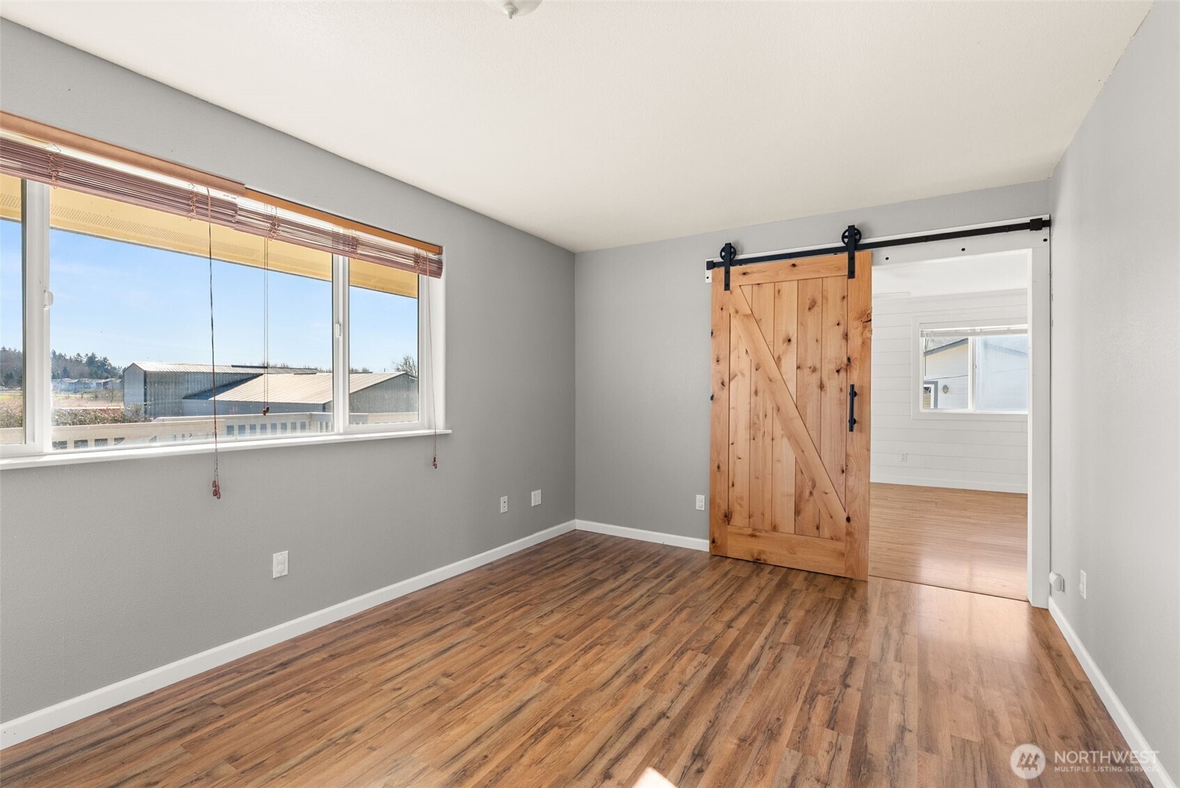 802 State Street Centralia, WA 98531 - Photo 18 of 40 an empty room with wooden floor and windows
