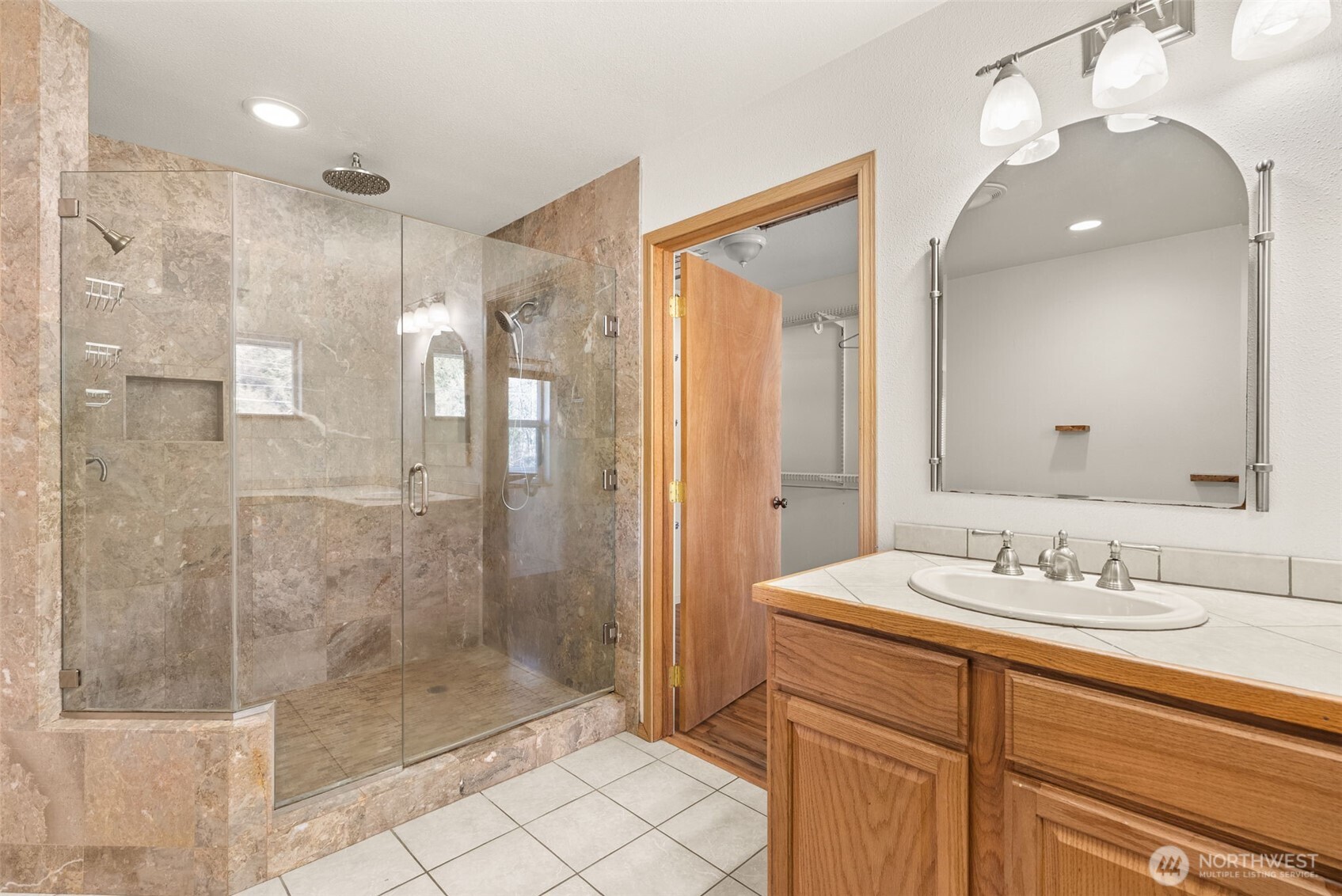 802 State Street Centralia, WA 98531 - Photo 19 of 40 a bathroom with a shower sink and mirror