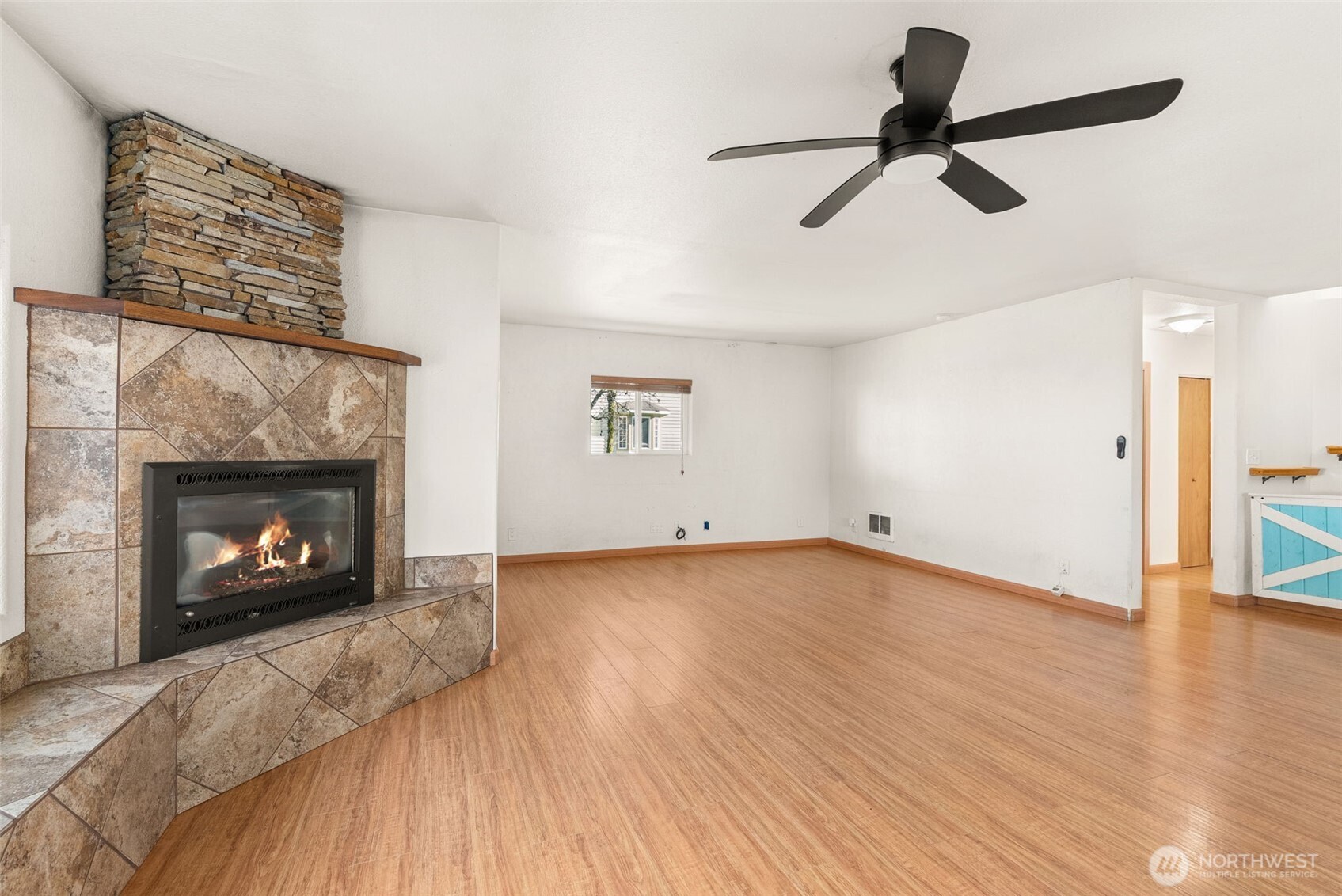 802 State Street Centralia, WA 98531 - Photo 3 of 40 a view of empty room with wooden floor fireplace and a window