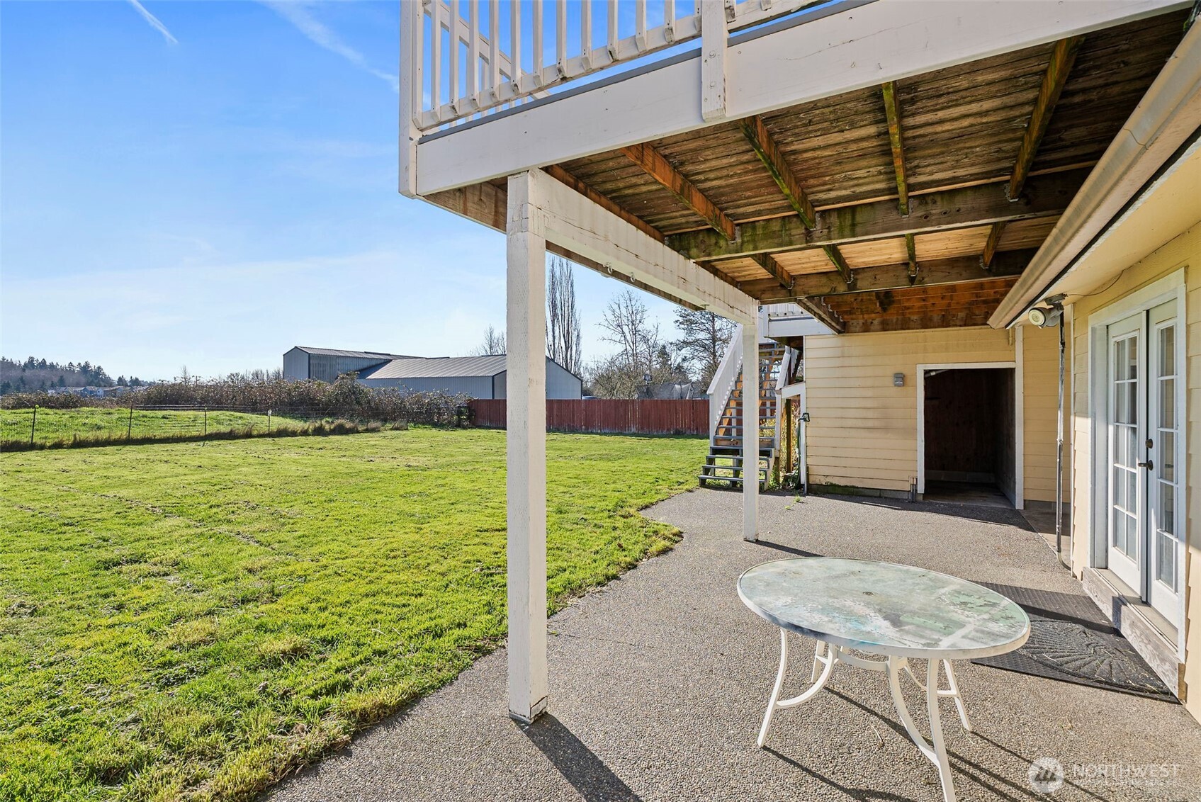 802 State Street Centralia, WA 98531 - Photo 32 of 40 a view of a patio with table and chairs with wooden floor and fence