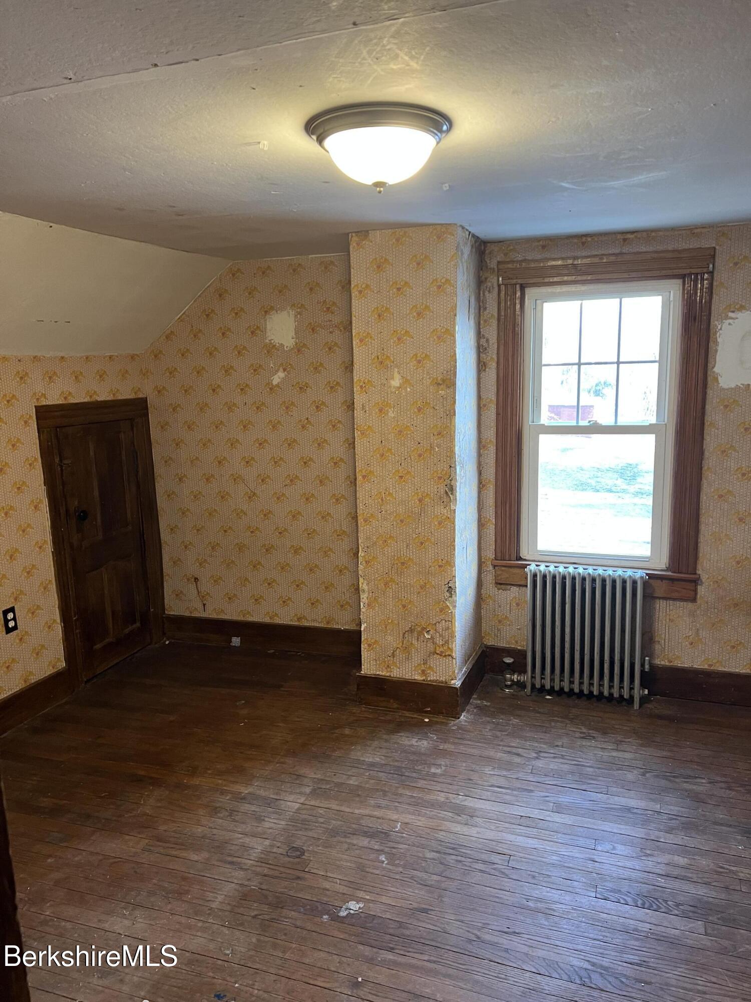 41 Willow Street Adams, MA 01220 - Photo 15 of 25 an empty room with wooden floor and windows