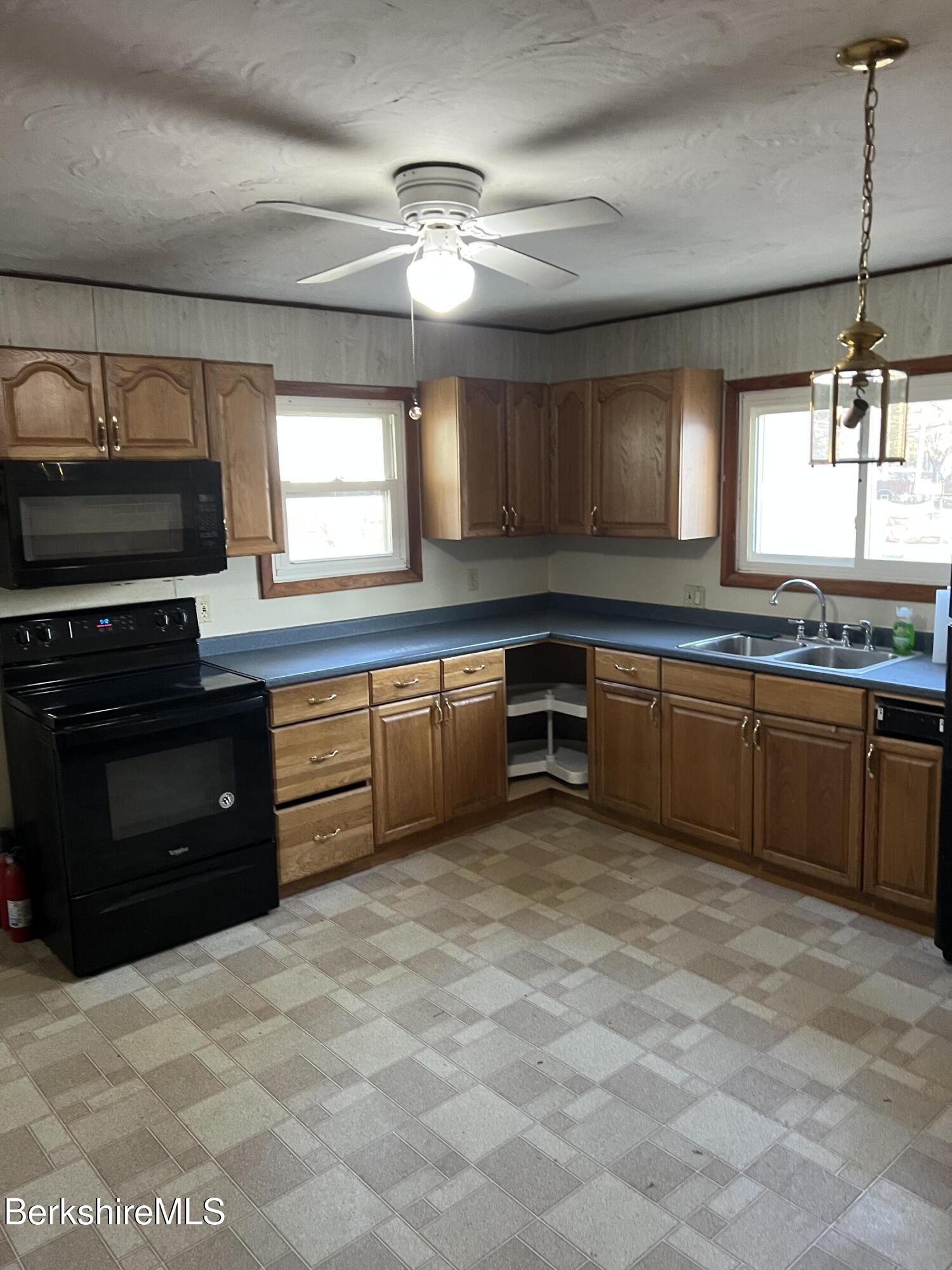 41 Willow Street Adams, MA 01220 - Photo 5 of 25 a kitchen with stainless steel appliances granite countertop a sink and cabinets