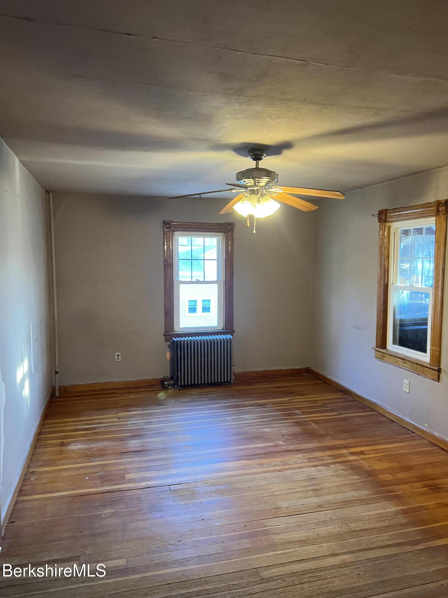 41 Willow Street Adams, MA 01220 - Photo 6 of 25 a view of an empty room with window and wooden floor