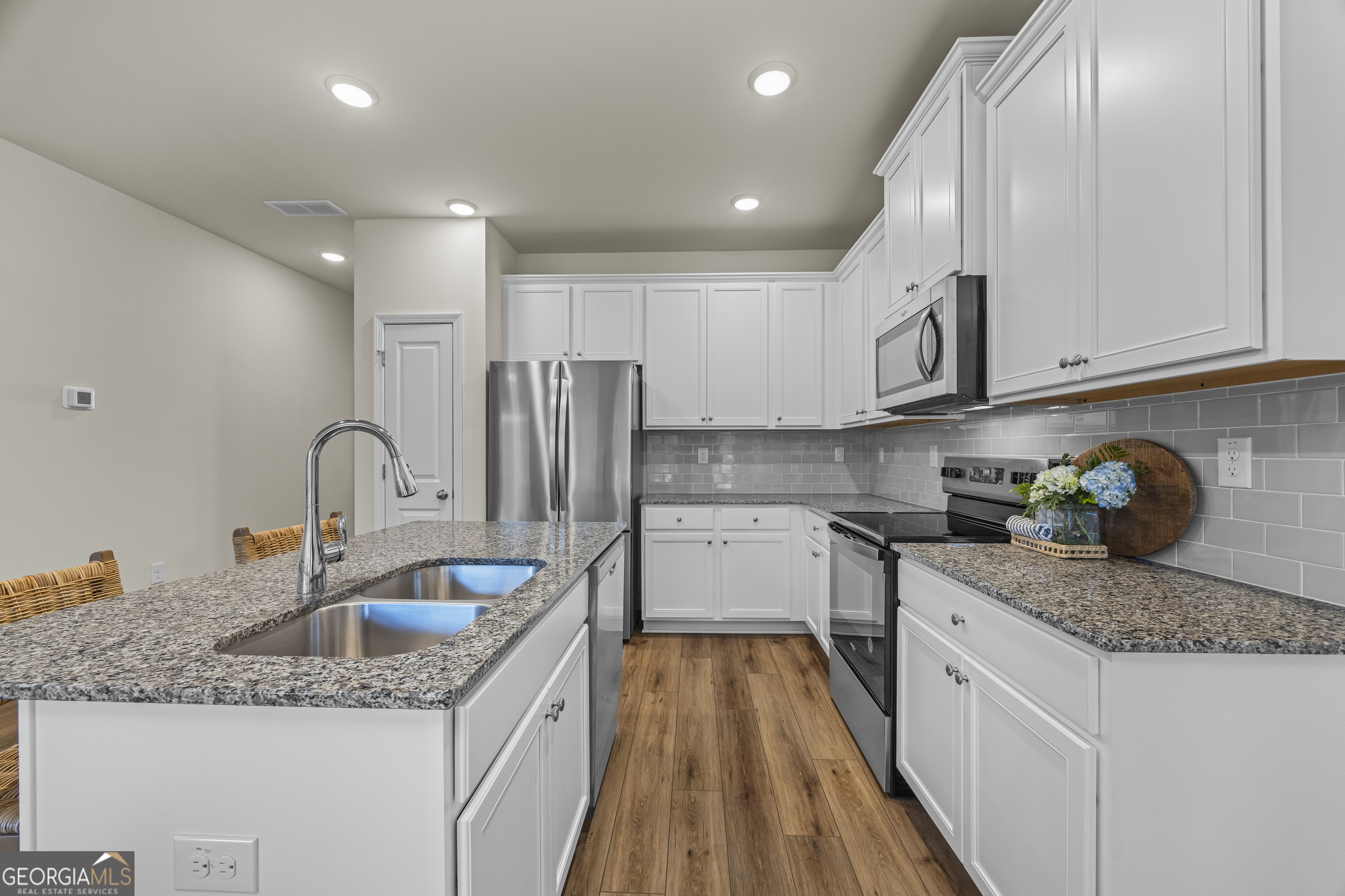 550 Buxton Road Hoschton, GA 30548 - Photo 13 of 57 a kitchen with stainless steel appliances granite countertop a sink stove and refrigerator