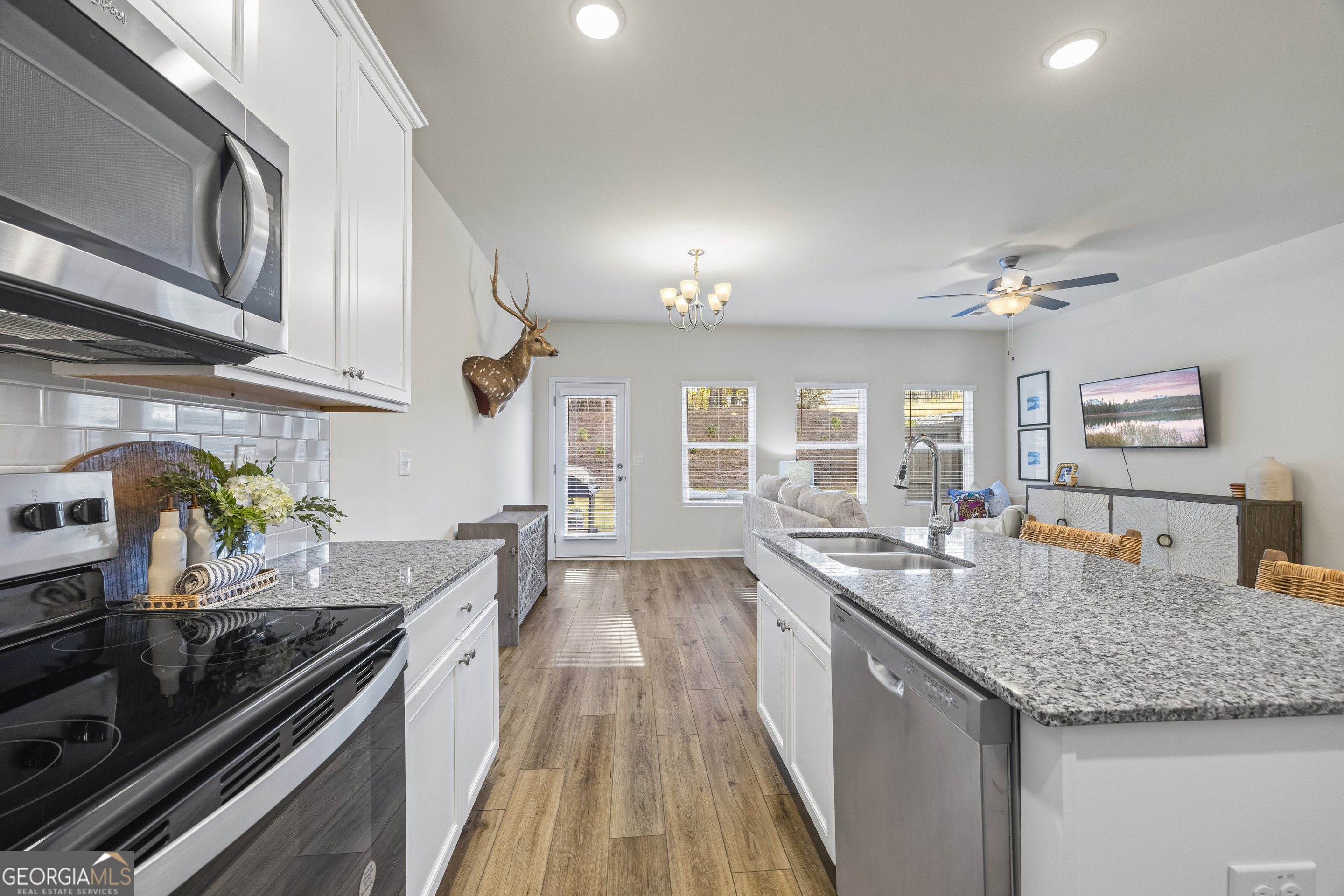 550 Buxton Road Hoschton, GA 30548 - Photo 14 of 57 a kitchen with sink stove and cabinets