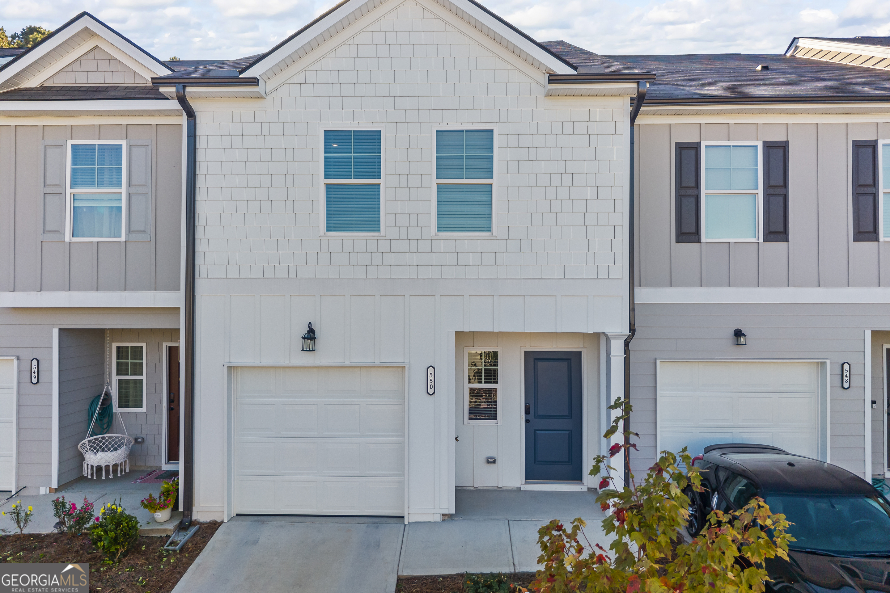 550 Buxton Road Hoschton, GA 30548 - Photo 2 of 57 a front view of a house with a garden and a porch
