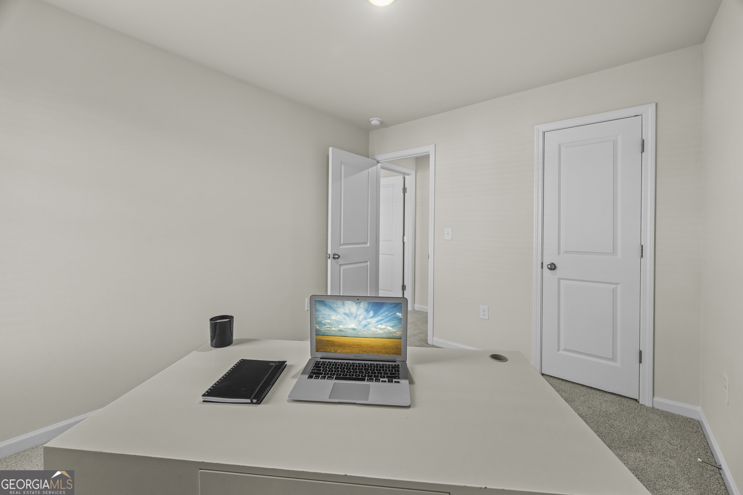 550 Buxton Road Hoschton, GA 30548 - Photo 28 of 57 a room that has a bed and a window in it