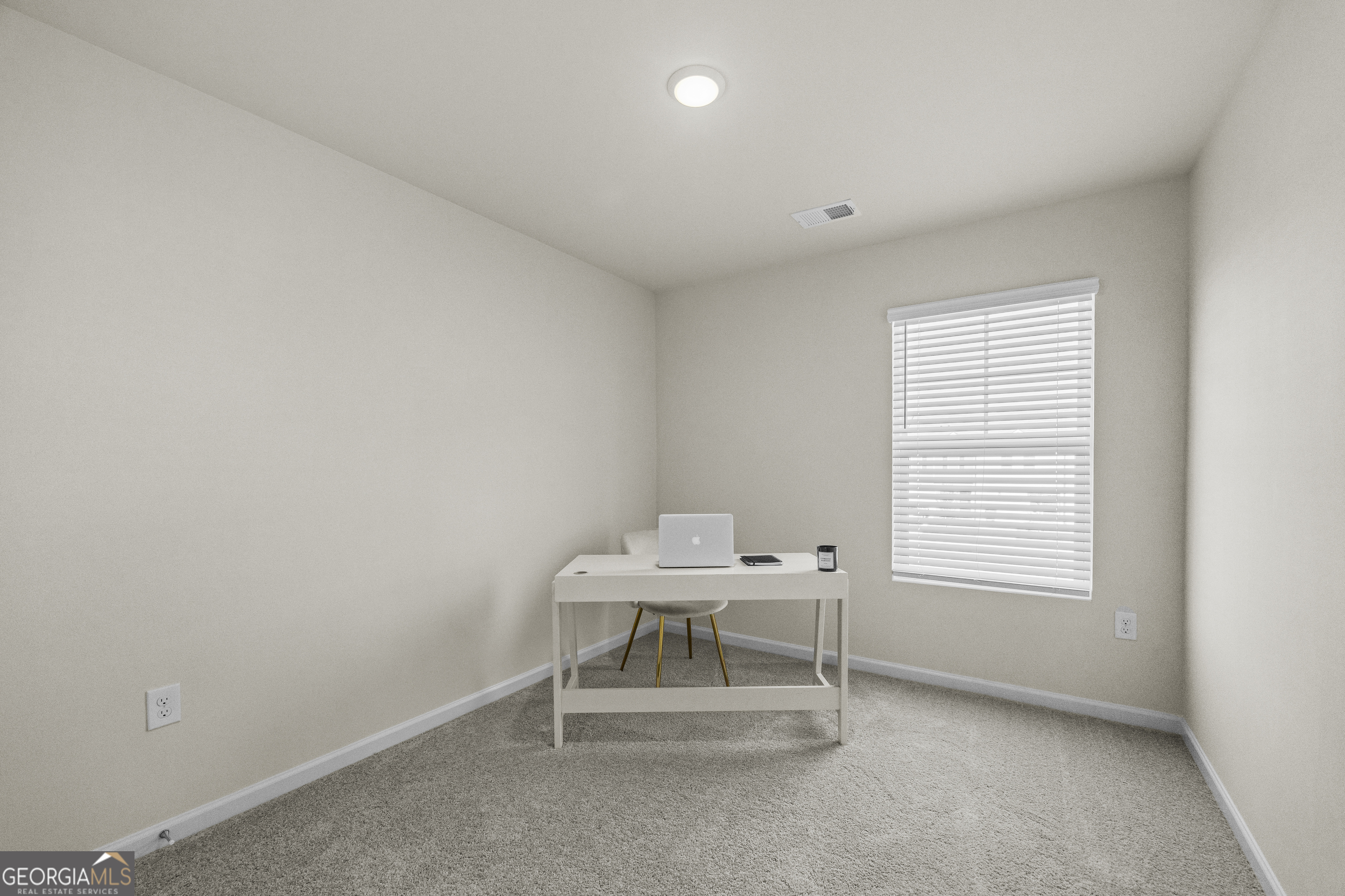 550 Buxton Road Hoschton, GA 30548 - Photo 29 of 57 a white room with a chair and a window