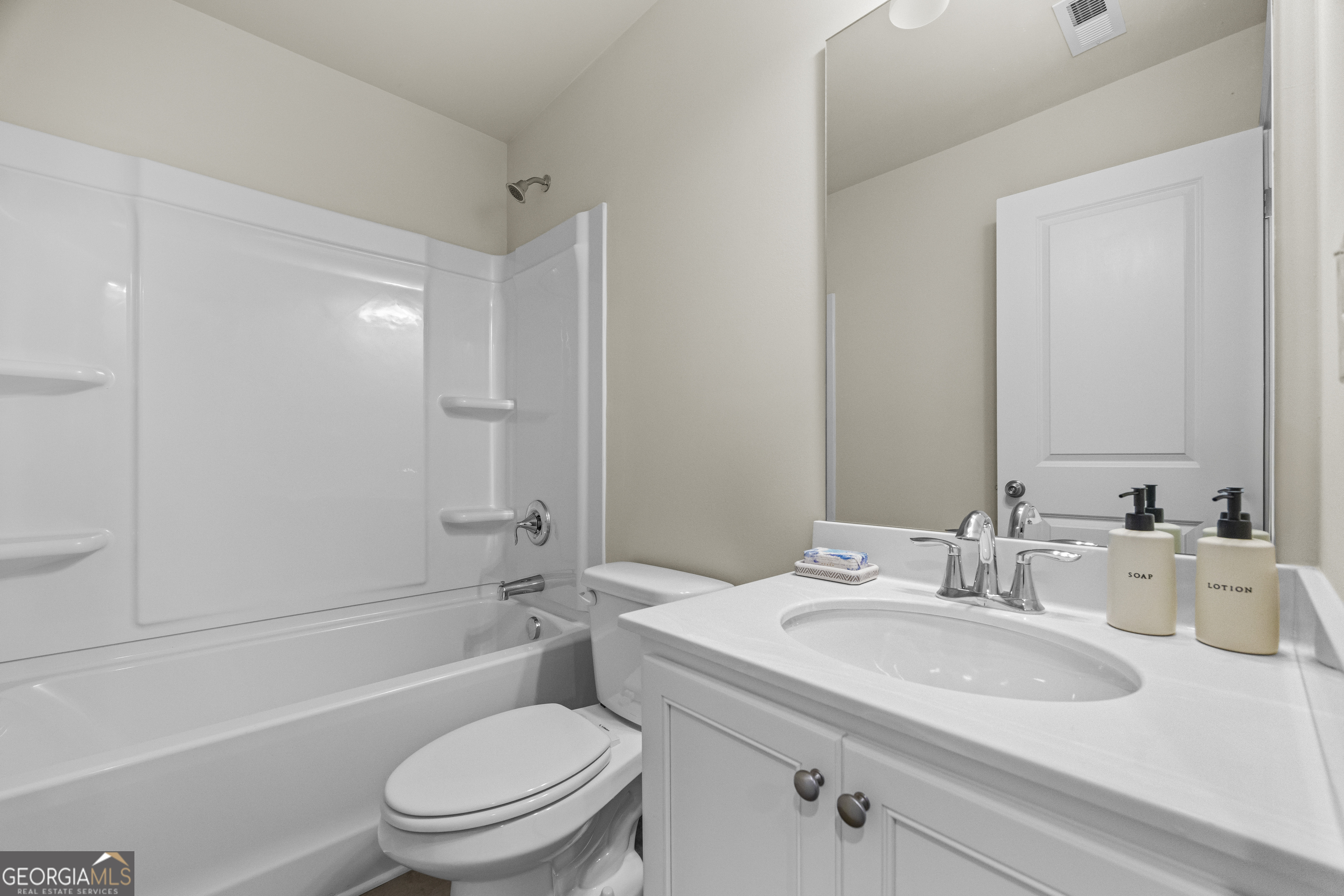 550 Buxton Road Hoschton, GA 30548 - Photo 31 of 57 a bathroom with a granite countertop sink toilet and shower