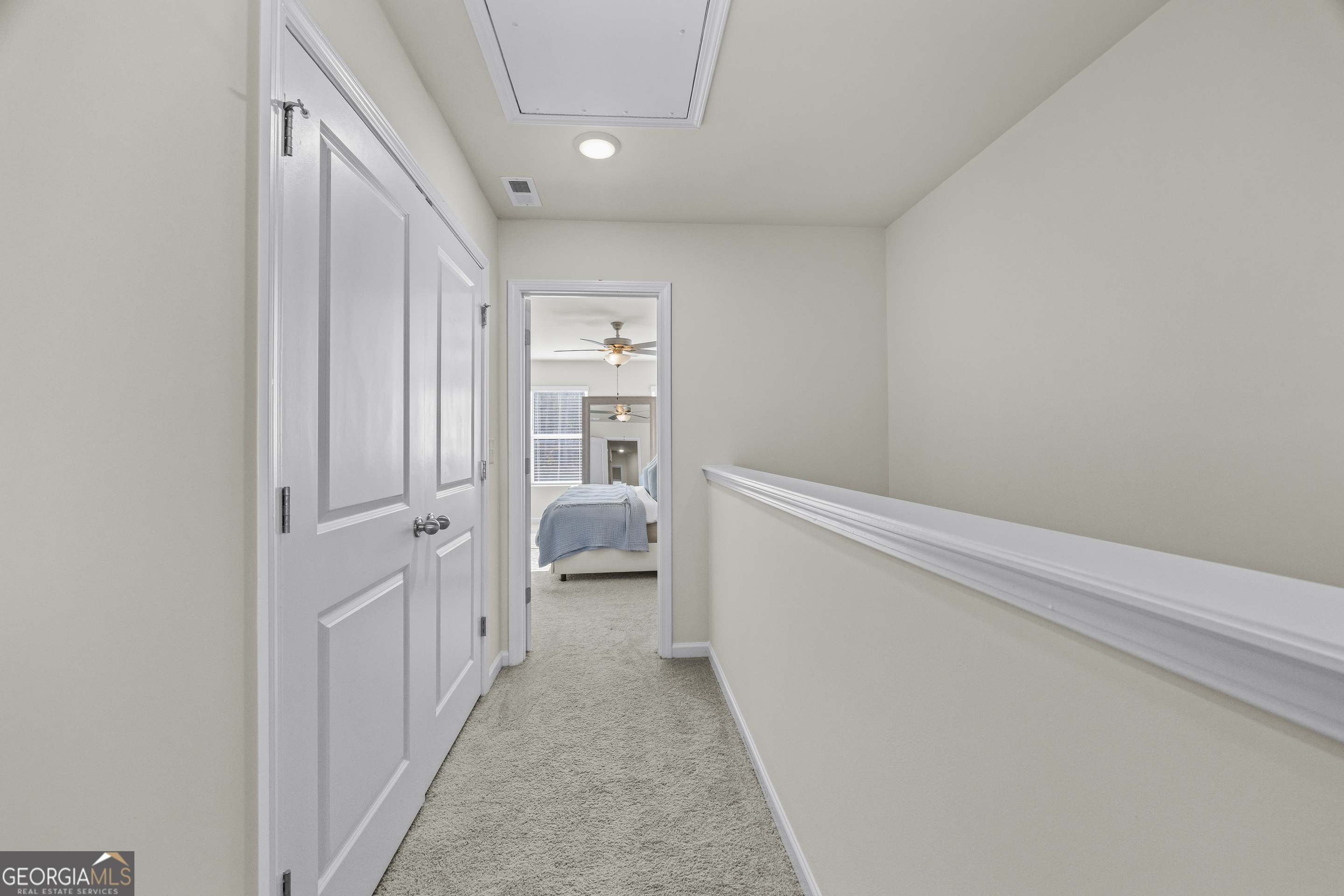 550 Buxton Road Hoschton, GA 30548 - Photo 34 of 57 a view of a hallway with a livingroom and a bathroom with sink