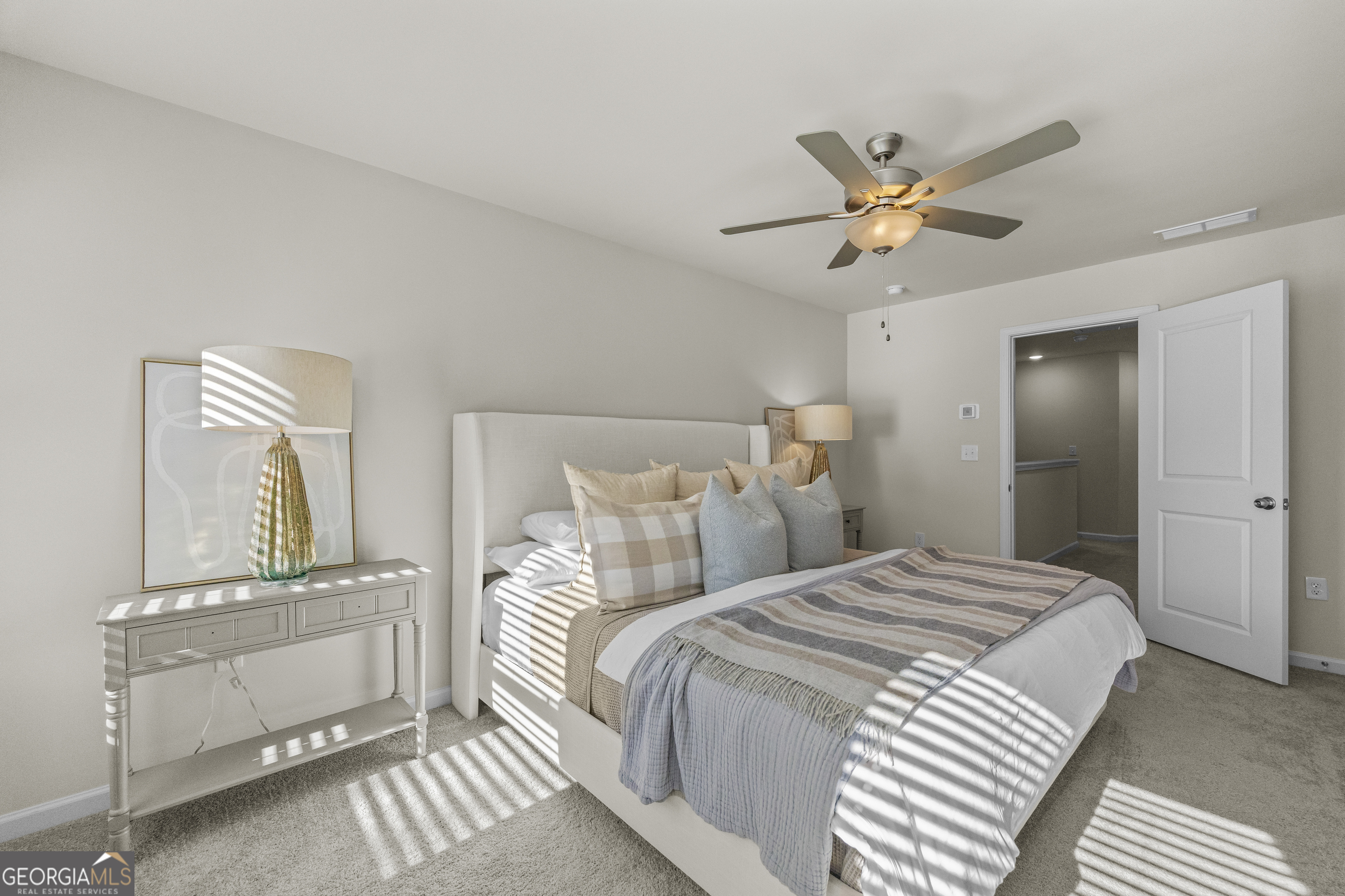 550 Buxton Road Hoschton, GA 30548 - Photo 38 of 57 a bedroom with a bed and a chandelier