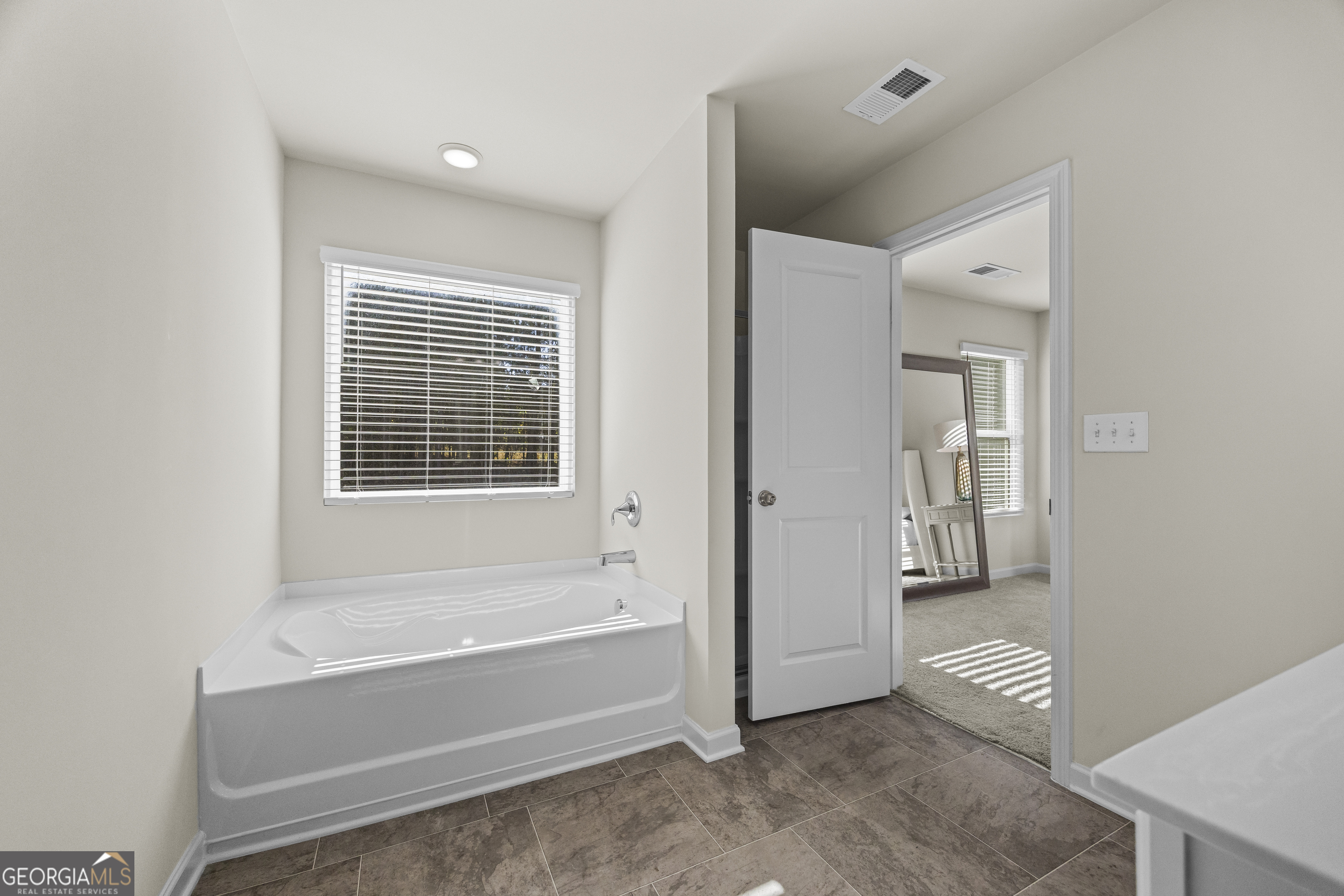 550 Buxton Road Hoschton, GA 30548 - Photo 42 of 57 a bathroom with a bathtub and a shower