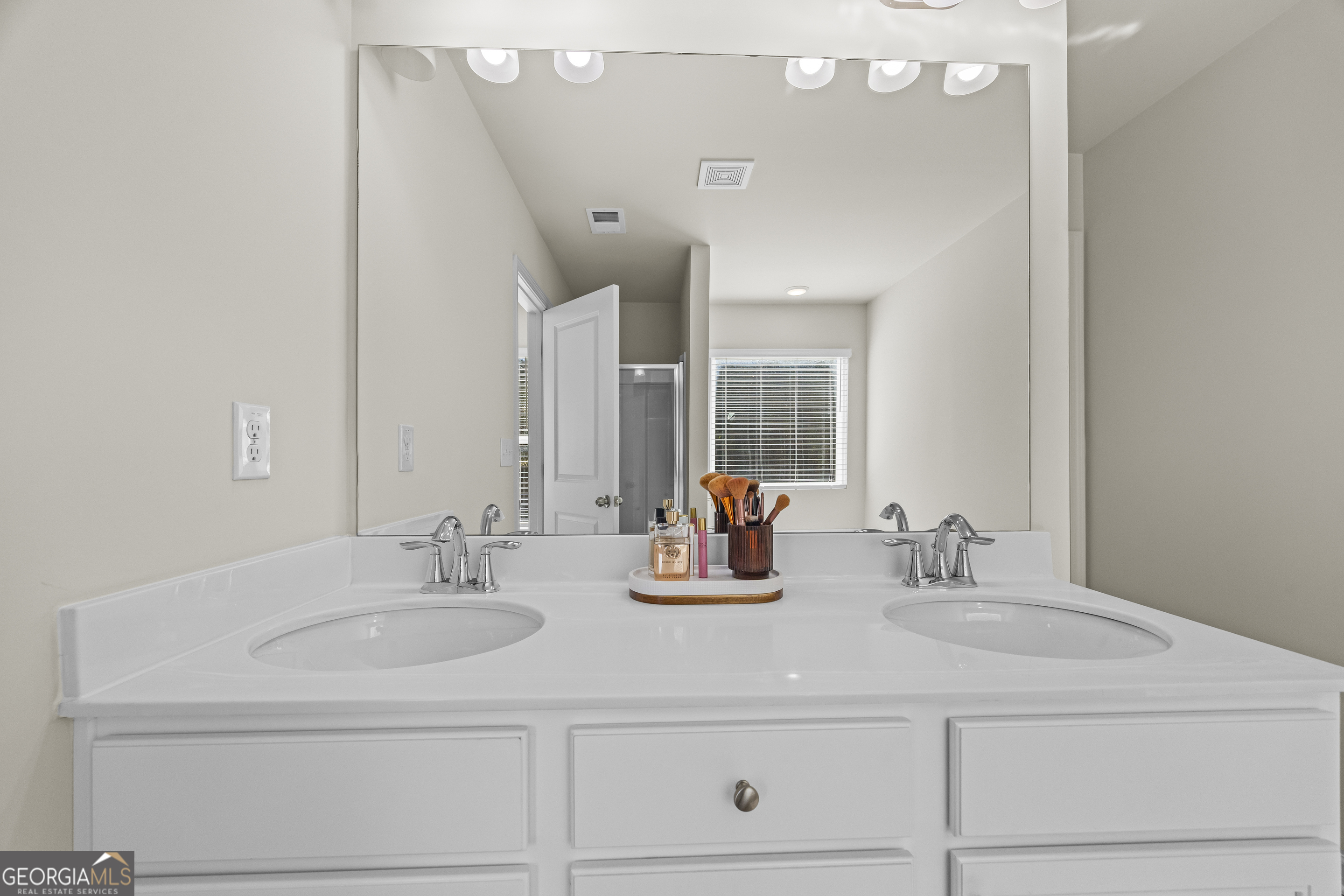 550 Buxton Road Hoschton, GA 30548 - Photo 45 of 57 a bathroom with double vanity sinks and a mirror