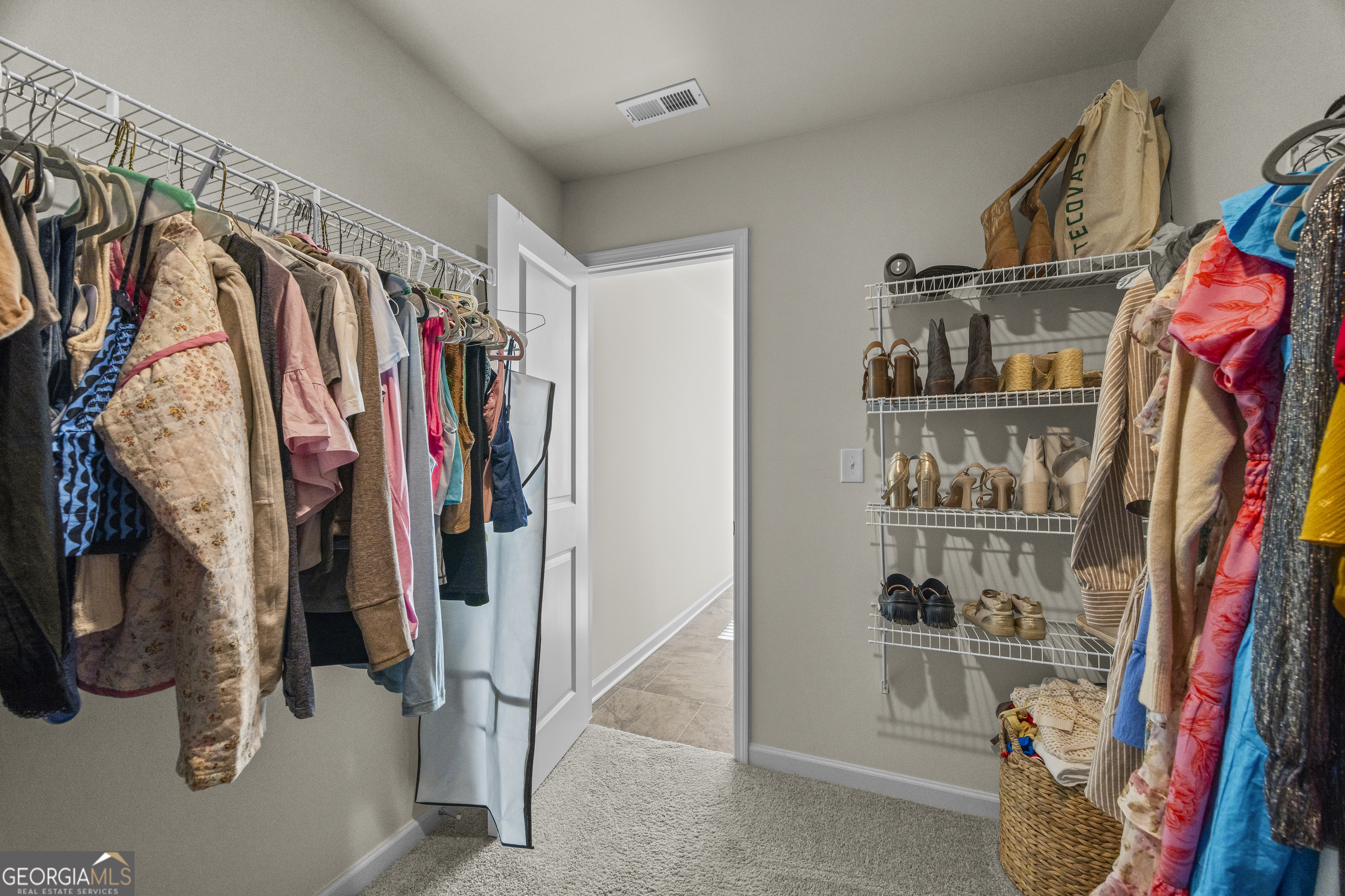 550 Buxton Road Hoschton, GA 30548 - Photo 47 of 57 a view of walk in closet with clothes and shoes