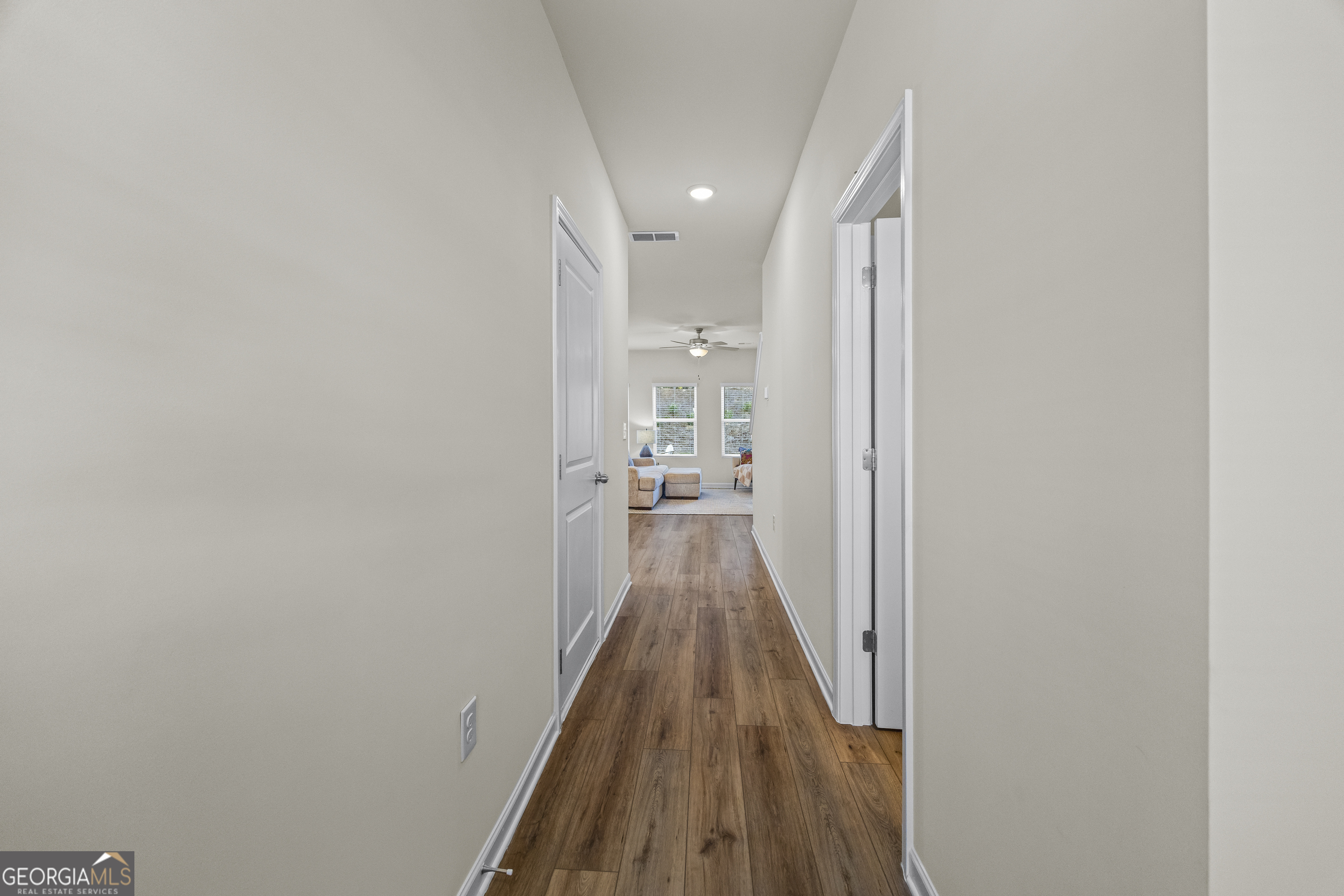 550 Buxton Road Hoschton, GA 30548 - Photo 5 of 57 a view of a hallway with wooden floor and a bathroom