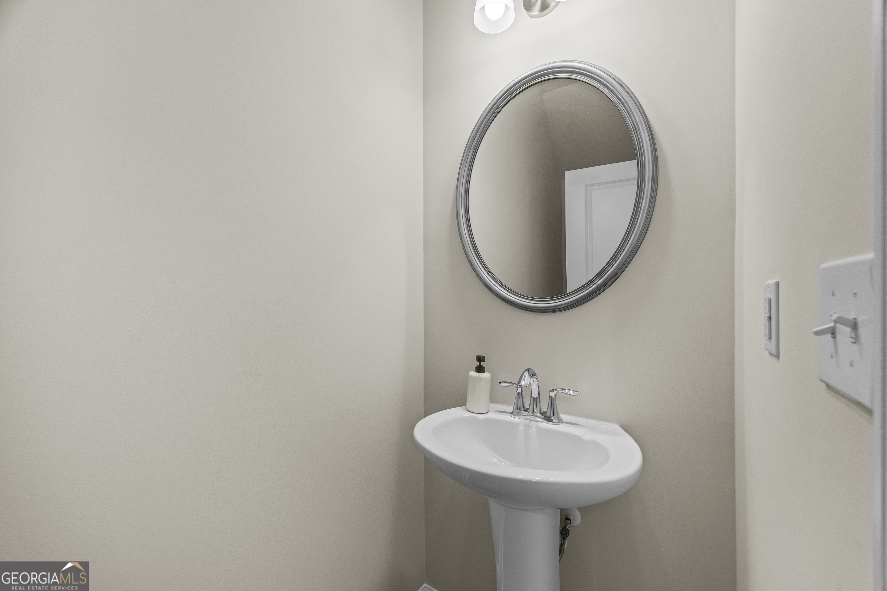 550 Buxton Road Hoschton, GA 30548 - Photo 7 of 57 a bathroom with a sink and a mirror