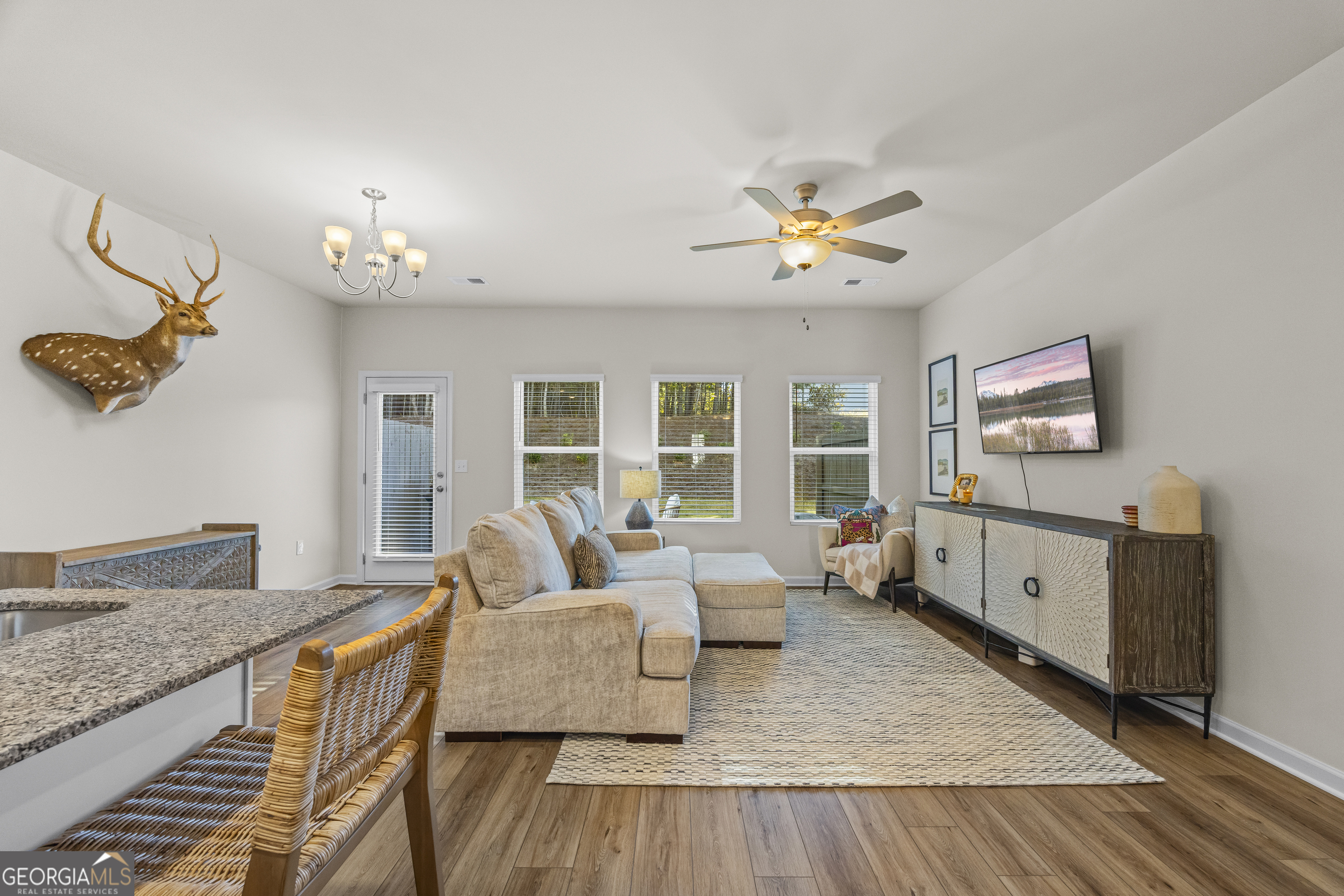 550 Buxton Road Hoschton, GA 30548 - Photo 10 of 57 a living room with furniture and a flat screen tv