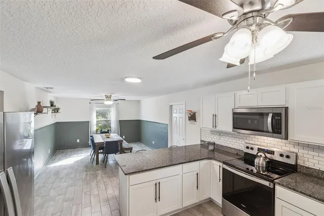 a kitchen with refrigerator and stove
