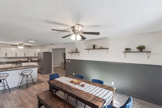 a kitchen with refrigerator and cabinets