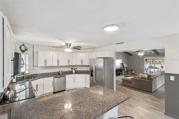 a kitchen with refrigerator and cabinets
