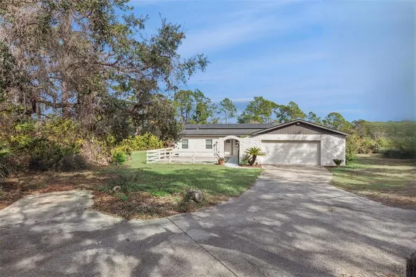 a view of house with a big yard