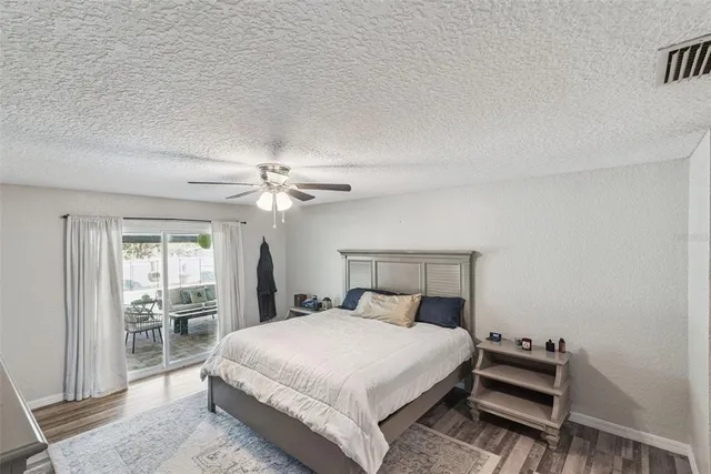 a view of a patio with a table and chairs under an umbrella