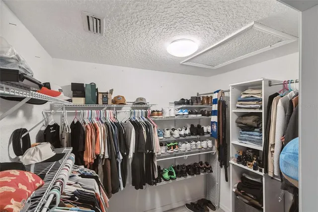 a white house with green field in front of it