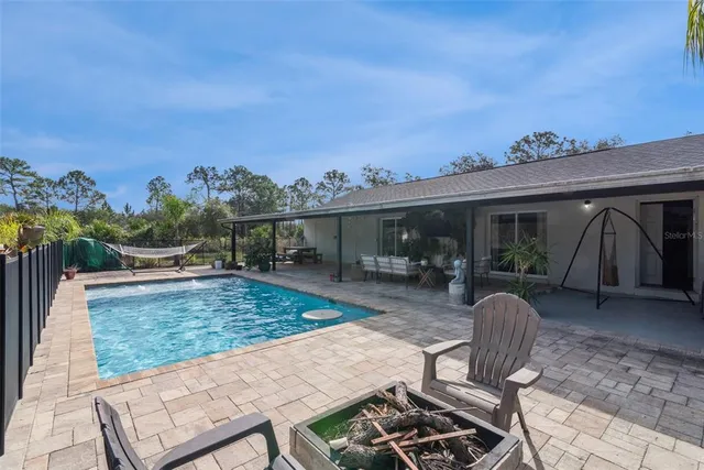 an aerial view of a house with a yard and trees