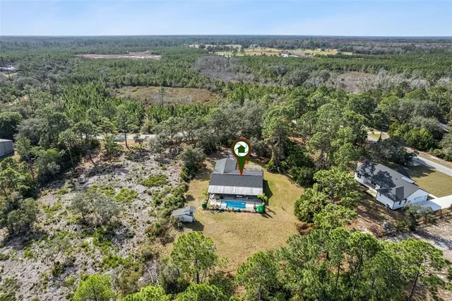 an aerial view of a house with a yard