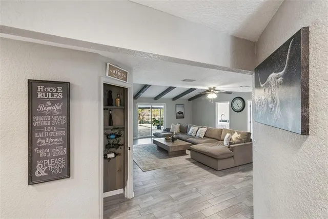 a living room with stainless steel appliances kitchen island granite countertop furniture and a fireplace