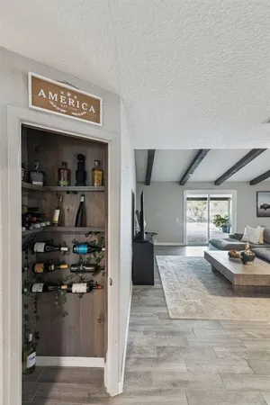 a living room with stainless steel appliances kitchen island granite countertop furniture and a fireplace