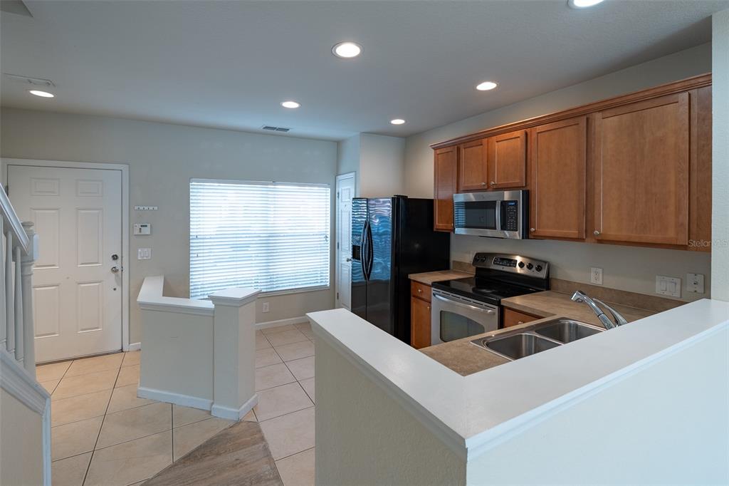 4900 Southwest 45th Street Ocala, FL 34474 - Photo 12 of 44 a kitchen that has a sink and a stove in it