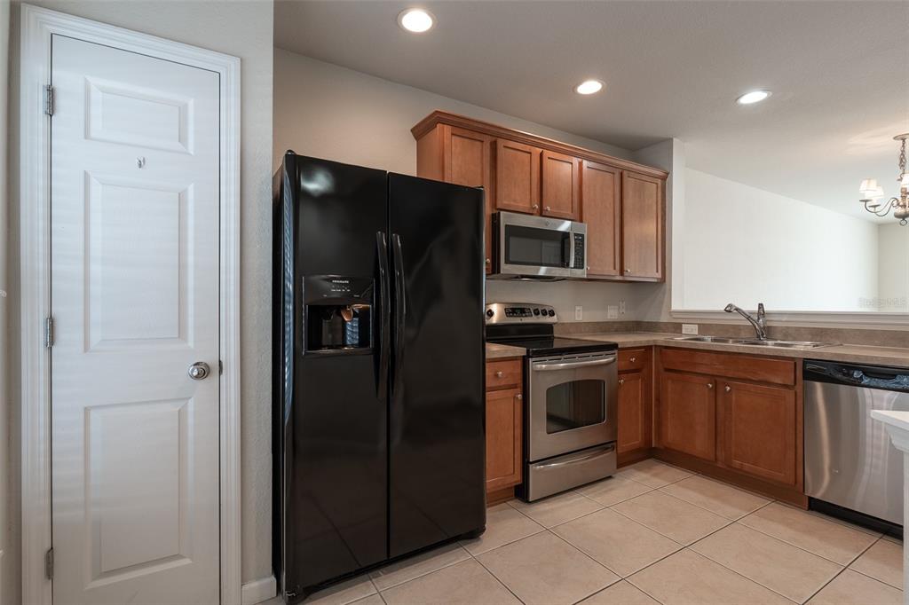 4900 Southwest 45th Street Ocala, FL 34474 - Photo 15 of 44 a kitchen with stainless steel appliances granite countertop a refrigerator and a sink